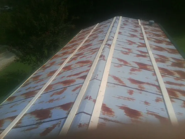 Rusted metal roof panels with new wood purlins before replacement — Storm Damage Roof Repair in Clay City by Roofing Brothers
