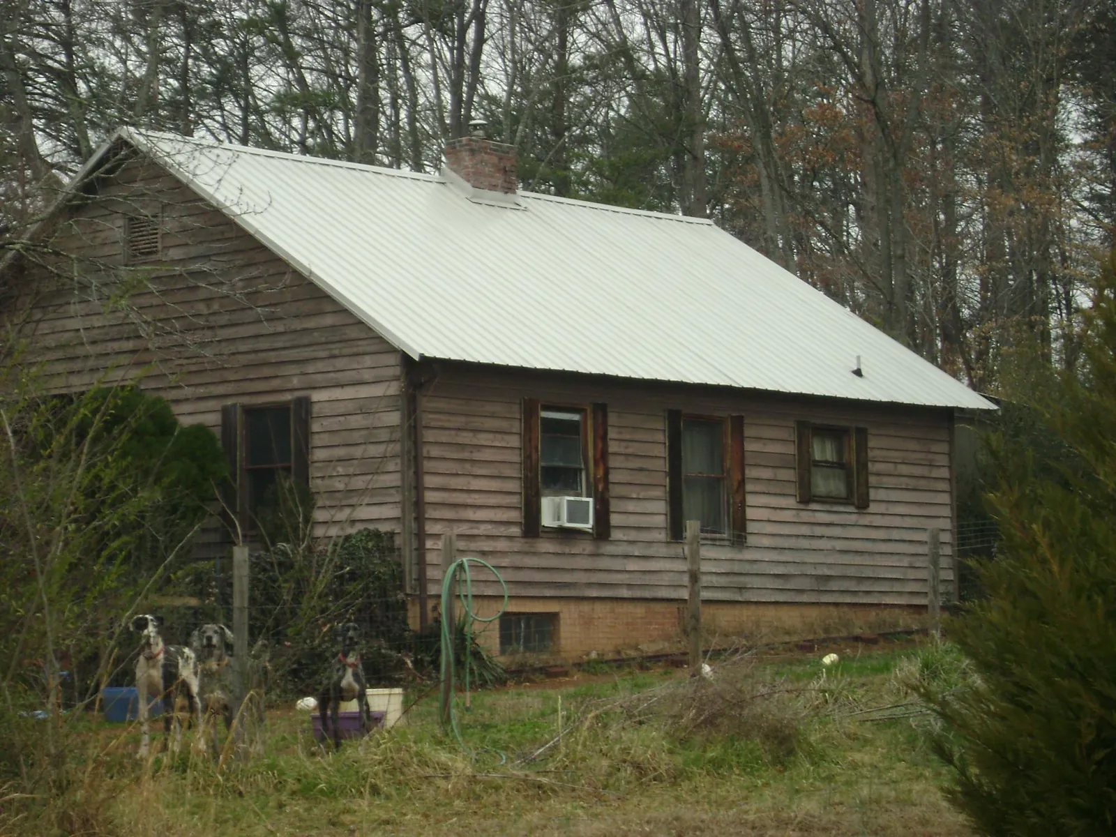 White metal roof on an old wood sided farmhouse, from a Metal Roof Installation job in Clay City